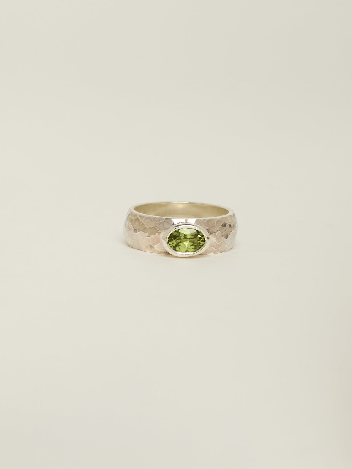 chunky silver ring with a bezel set peridot