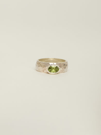 chunky silver ring with a bezel set peridot