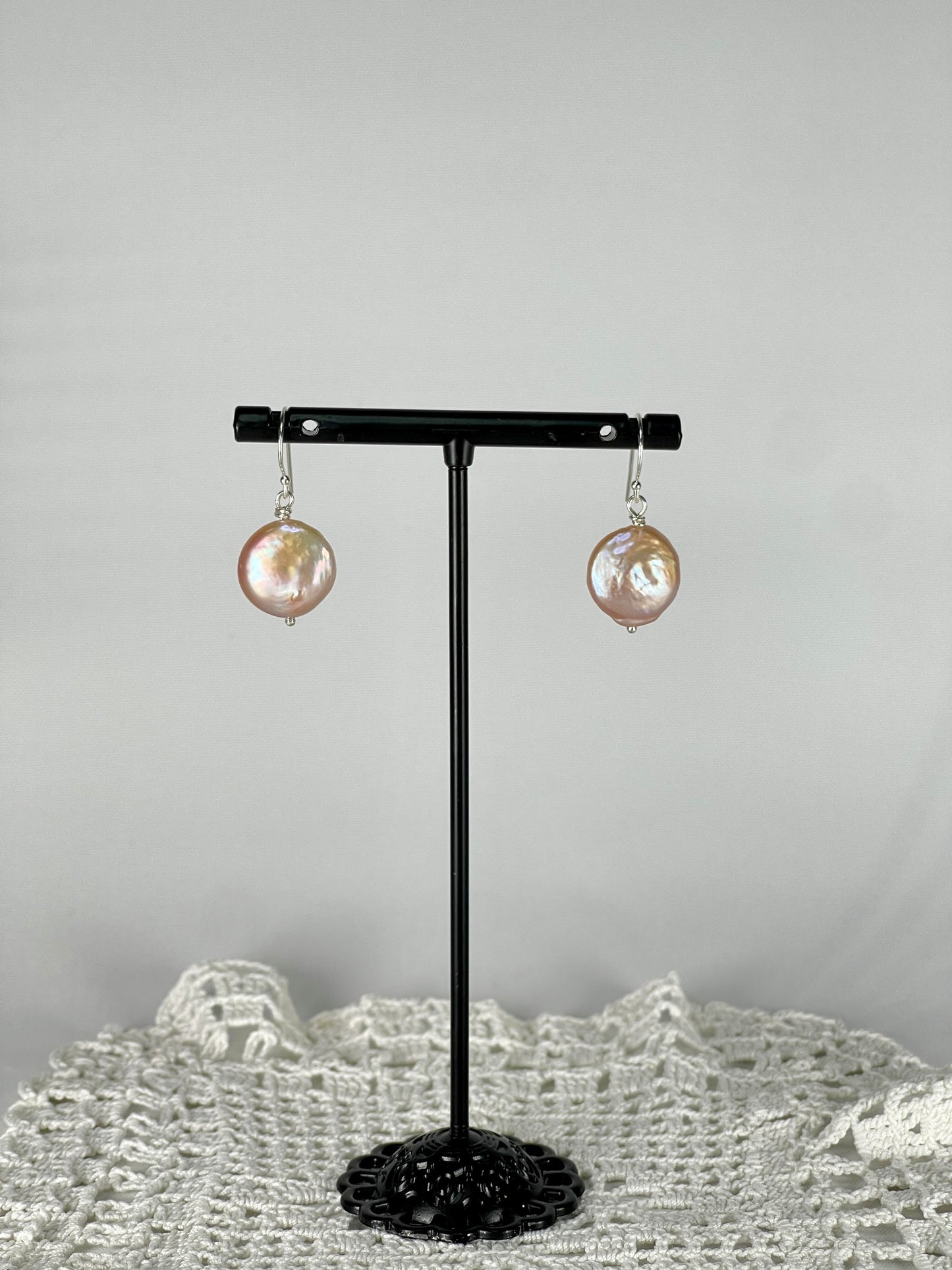 Silver single drop earrings with a peach coloured pearl