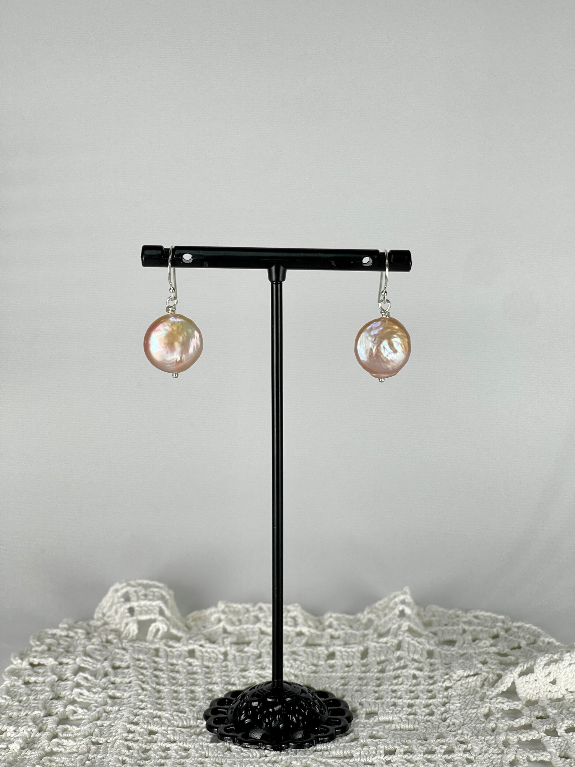 Silver single drop earrings with a peach coloured pearl