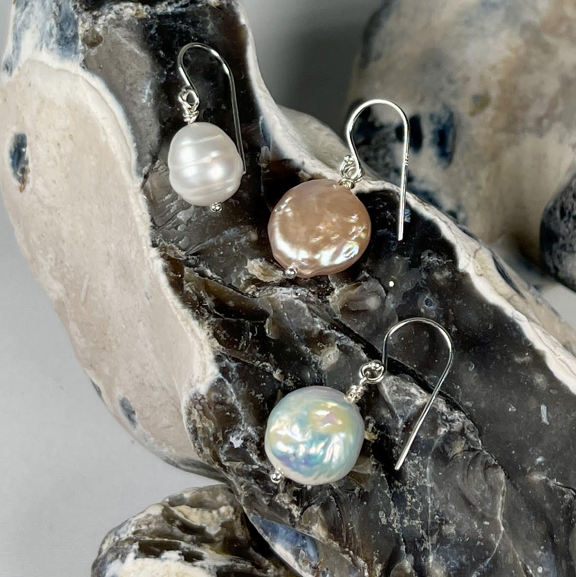 A collection of single drop silver pealrs.